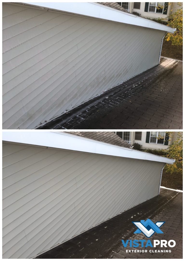 Pressure washing upper level siding in West Bend.