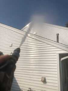 Power washing a second story house from the ground