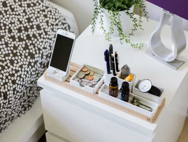 Organized side bed table with phone displayed.