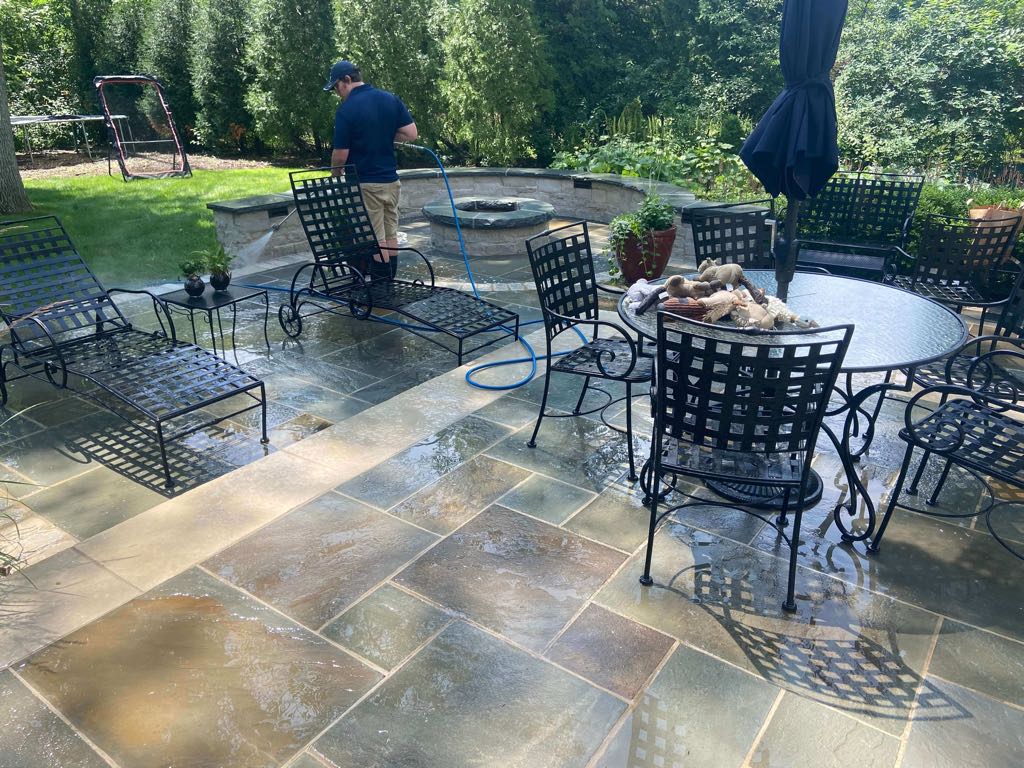 Wet patio being cleaned