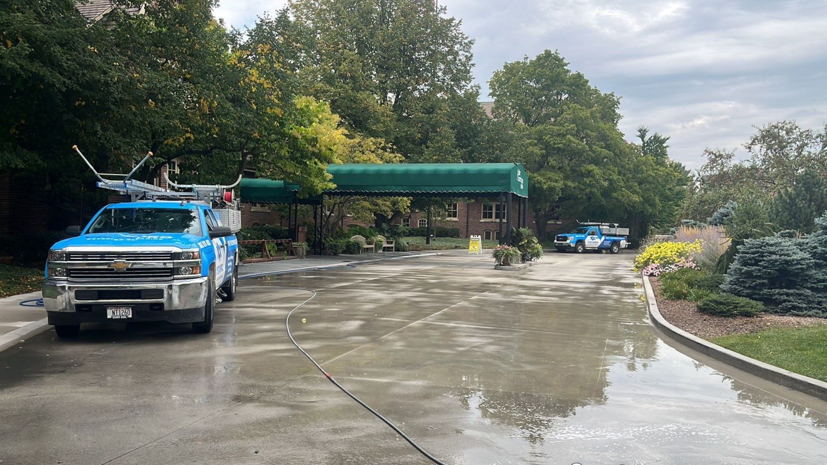Picture of two trucks pressure washing concrete in Kohler, WI.