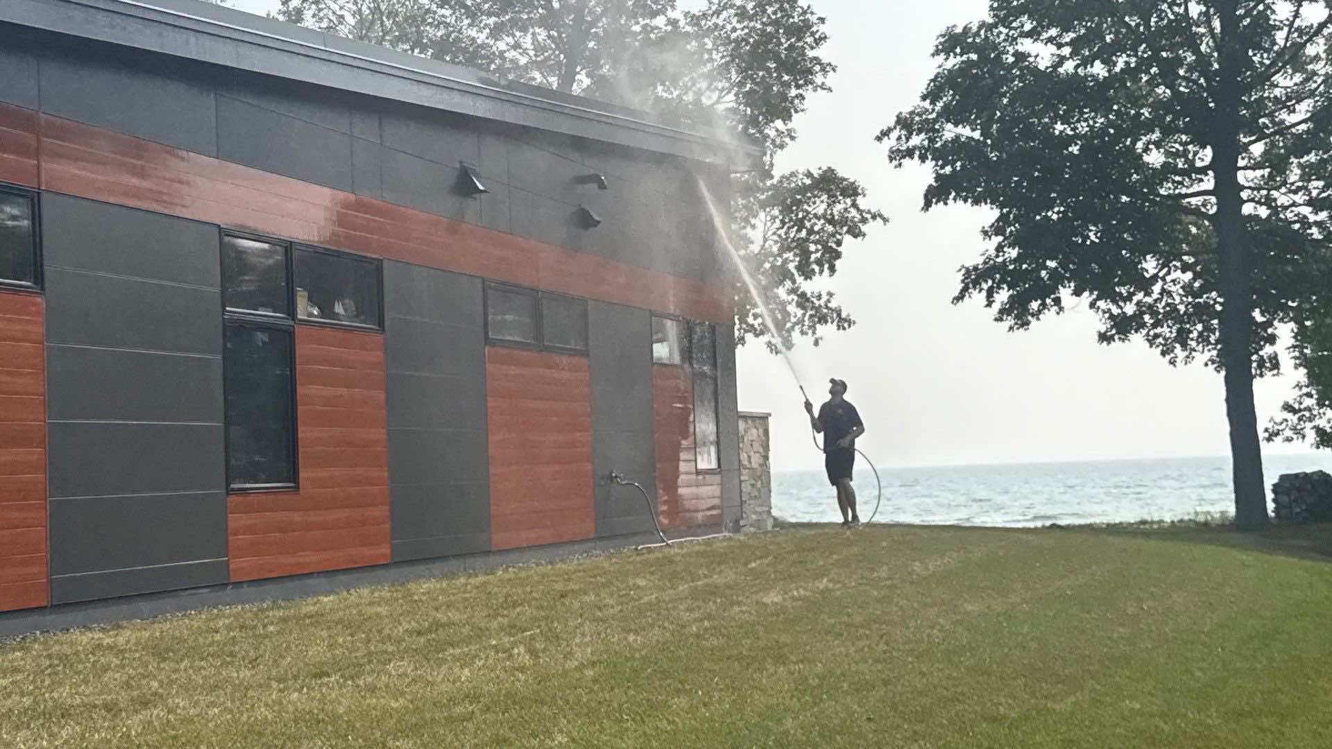 House washing being done on a house in Belgium, WI on the shores of Lake Michigan in 2025.
